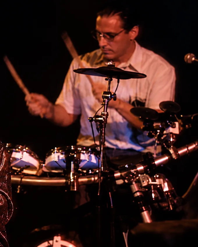Tony on drums with The Ducks, sticks raised mid-beat